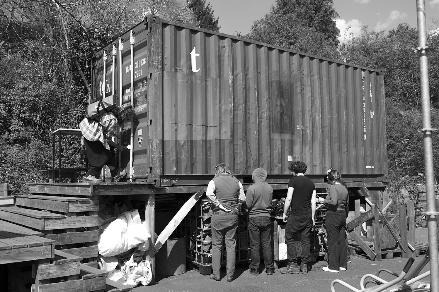 The group listening closely and recording a container used for storage at floating.